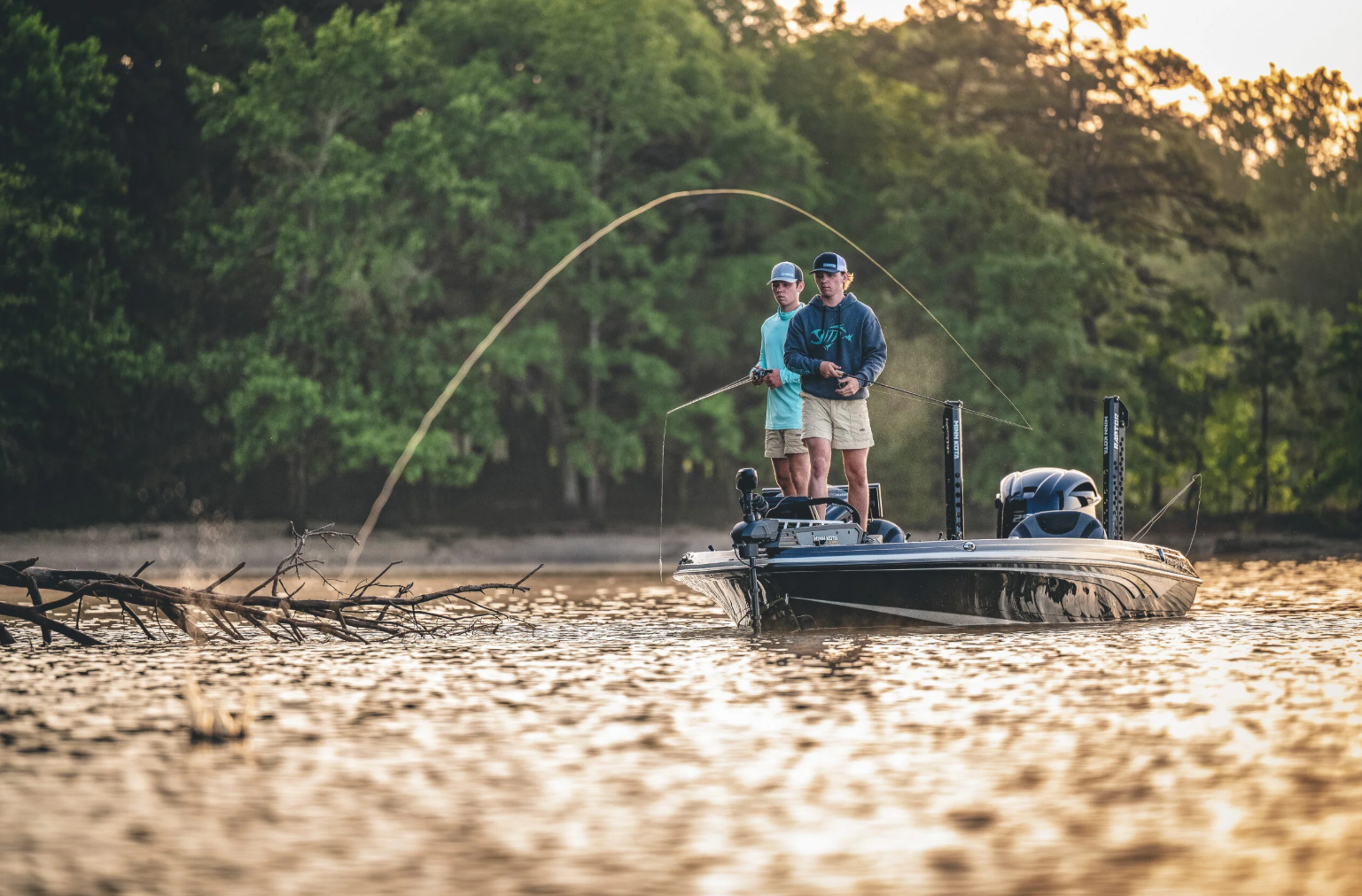 Two anglers casting from a bass boat